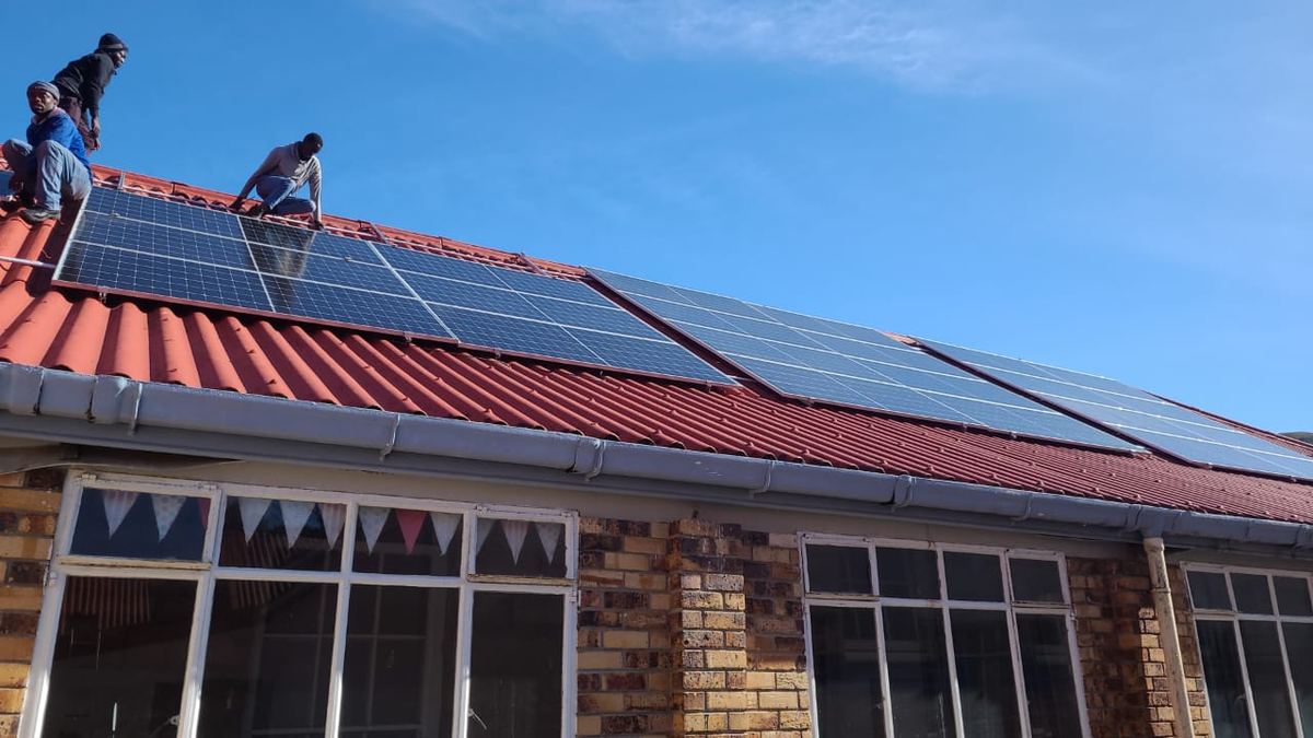 OSC team installing rooftop solar panels